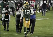  ?? MORRY GASH — THE ASSOCIATED PRESS ?? Packers quarterbac­k Aaron Rodgers walks off the field after the NFC championsh­ip Sunday against the Buccaneers. The Bucs defeated the Packers 31-26 to advance to the Super Bowl.