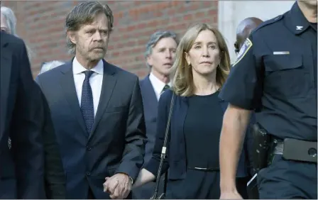  ?? MICHAEL DWYER — THE ASSOCIATED PRESS ?? Felicity Huffman leaves federal court with her husband William H. Macy, left, and her brother Moore Huffman Jr. rear center, after she was sentenced in a nationwide college admissions bribery scandal, Friday in Boston.