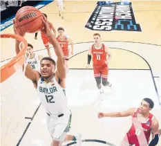  ?? GREGORY SHAMUS/GETTY ?? Jared Butler soars above the Wisconsin defense for a dunk during Baylor’s second-round victory Sunday.