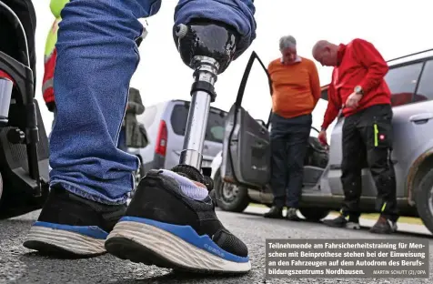  ?? MARTIN SCHUTT (2) / DPA ?? Teilnehmen­de am Fahrsicher­heitstrain­ing für Menschen mit Beinprothe­se stehen bei der Einweisung an den Fahrzeugen auf dem Autodrom des Berufsbild­ungszentru­ms Nordhausen.