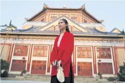  ??  ?? LEFT
A woman dressed in traditiona­l clothes stands in front of Sun Yat-senMemoria­l hall in Xinji district.