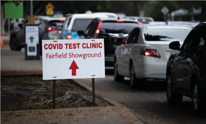  ?? Photograph:Carly Earl/The Guardian ?? Long queues snake around the Fairfield Showground car park on Wednesday as locals wait hours to receive a Covid test. Essential workers who live in the area must now get tested every three days if they work outside the area.