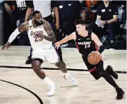  ?? DOUGLAS P. DEFELICE TNS ?? ‘I learned a lot. I feel like I was thrown into the fire early,’ Tyler Herro, here dribbling against LeBron James, said of his rookie season.