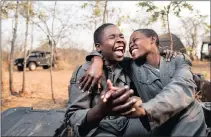  ??  ?? TEAM OF ACHIEVERS: Nyaradzo and Petronella are two of the most promising women on the programme and among the first female anti-poaching managers in the region to have risen through the ranks. The women share some downtime during the gruelling training...