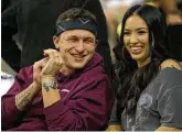  ?? Sam Craft / AP ?? Johnny Manziel sits with his fiancé, Bre Tiesi, during a basketball game between Kentucky and Texas A&M on Saturday.