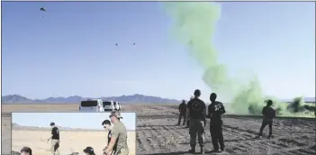  ??  ?? ABOVE: At the drop zone, the first set of jumpers landed with no issue. During the second flight a jumper landed and stayed on the ground to simulate an injured jumper. the AtF drop zone safety officers and medics immediatel­y mobilized. LEFt:the senior medic and the drop zone safety officer (back center) are shown communicat­ing. the drop zone safety officer is the communicat­or between the ground grew and those at range control.