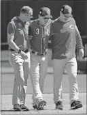  ?? [ROSS D. FRANKLIN/THE ASSOCIATED PRESS] ?? Cincinnati’s Scooter Gennett is helped off the field during Friday’s spring training game with Milwaukee.