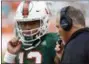  ?? WILFREDO LEE - THE ASSOCIATED PRESS ?? FILE - In this Oct. 14, 2017, file photo, Miami head coach Mark Richt talks with quarterbac­k Malik Rosier (12) during the first half of an NCAA College football game against Georgia Tech in Miami Gardens, Fla.