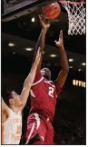  ?? AP/SHAWN MILLSAPS ?? Arkansas forward Adrio Bailey (2) shoots over Tennessee forward John Fulkerson during the Razorbacks’ 106-87 loss to the No. 3 Volunteers on Tuesday at Thompson-Boling Arena in Knoxville, Tenn.