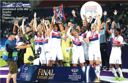  ??  ?? The Lyon girls celebrate after being presented with the trophy Photo: Domenic Aquilina