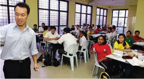  ??  ?? Listen up: One of the teachers at Harvest Centre, Deshon Max, 22, from Johor, teaching Bahasa Malaysia in a Form 2 class.