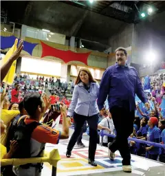  ?? REUTERS ?? Venezuela’s President Nicolas Maduro and his wife Cilia Flores attend an event with supporters in Caracas on Wednesday.