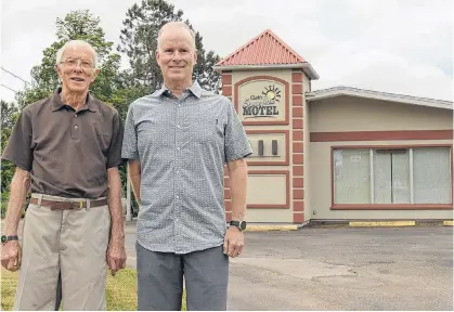  ??  ?? Brad Clark, left, and Myles Clark check on Clark's Sunny Isle Motel July 5. The summer of 2020 will be the first in 57 years that the motel has not opened.