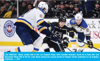  ??  ?? LOS ANGELES: Blake Lizotte #46 of the Los Angeles Kings stick handles between Jacob de la Rose #61 and Alexander Steen #20 of the St. Louis Blues during the second period at Staples Center yesterday in Los Angeles, California. — AFP