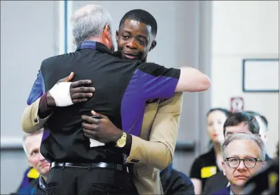  ?? Wade Payne ?? The Associated Press James Shaw Jr., right, gets a hug Sunday from Waffle House CEO Walt Ehmer during a news conference on the Waffle House shooting in Nashville, Tenn. Shaw wrestled the gun from the suspect.