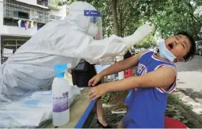  ?? Above, from left ?? A medical worker takes a swab from a child; Huoshensha­n Hospital, built in just over a week; a packed pool party at Maya Beach Water Park in August