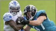  ?? PHELAN M. EBENHACK — THE ASSOCIATED PRESS ?? Detroit Lions running back D’andre Swift, left, is tackled by Jacksonvil­le Jaguars linebacker Joe Schobert after a short gain during the first half of a 2020game in Jacksonvil­le, Fla.