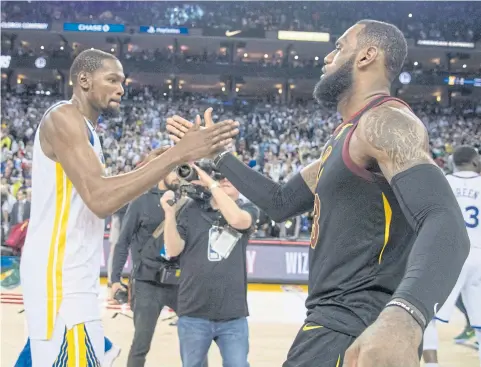  ??  ?? Warriors forward Kevin Durant, left, and Cavaliers forward LeBron James greet each other after a game last year.