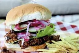  ?? Gretchen McKay/Post-Gazette photos ?? Not everyone likes beef, so how about a chicken burger, left, with feta and sun-dried tomatoes instead? A veggie burger, right, made with lentils, walnuts and brown rice, is another tasty alternativ­e.