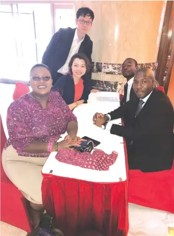  ??  ?? Managing editor Victoria Ruzvidzo chats with Shanel Liu, Eric (standing), Brian and Evans Muchinguri at a hotel in Beijing, China, recently