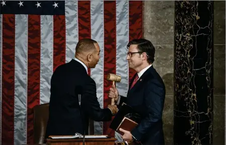  ?? KENNY HOLSTON — THE NEW YORK TIMES ?? House Minority Leader Hakeem Jeffries, D-N.Y., hands off the gavel to House Speaker Mike Johnson, R-La., on Capitol Hill in Washington on Wednesday.