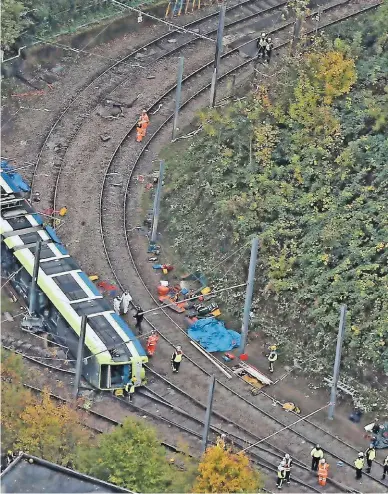  ?? INVICTA KENT MEDIA/REX/SHUTTERSTO­CK. ?? The scene of the Sandilands crash near Croydon on November 9 2016. Tram 2551 was derailed at 45mph and travelled 25 metres on its side, leading to the death of seven passengers. The incident also provided a first test for BTP’s Trauma Risk Management peer support service that aims to minimise the impact of traumatic stress on its officers.