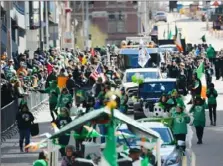  ?? Lake Fong/Post-Gazette ?? Pittsburgh’s St. Patrick’s Day Parade winds through Downtown in 2017. This year’s parade will march in September, following its postponeme­nt due to COVID-19 concerns.