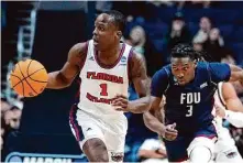  ?? Michael Conroy/Associated Press ?? Florida Atlantic guard Johnell Davis (1) had 29 points as the Owls ended No. 16 Fairleigh Dickinson’s season Sunday night.