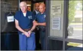  ?? DIGITAL FIRST MEDIA STAFF ?? Richard Wayne Reimers, 67, is led by police out of Montgomery Township district court after an appearance on Tuesday, Aug. 23.