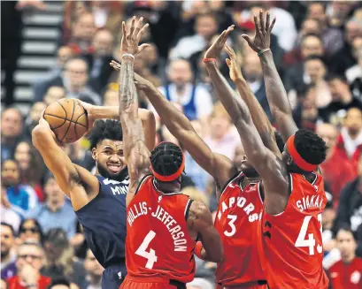  ?? RICHARD LAUTENS TORONTO STAR ?? Timberwolv­es centre Karl-Anthony Towns comes across some heavy Raptors defence on Monday at the Scotiabank Arena.