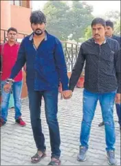  ?? HT PHOTO ?? Accused Dinesh Kumar (handcuffed) in police custody. Panipat police had brought him on production warrant.