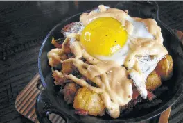  ??  ?? Poutine with brisket, tater tots, a fried egg and chipotle mayo didn’t live up to its promise.