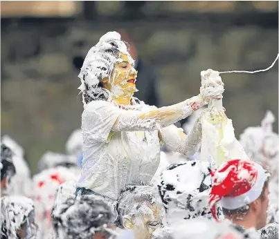  ?? Picture: Kris Miller. ?? Revellers taking part in the famous foam fight on the Lower College Lawn.