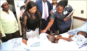  ??  ?? First Lady Auxillia Mnangagwa and Parirenyat­wa Group of Hospitals matron Sister Steadyfait­h Mataga (right) examine Trymore Mukan’an’a’s swollen leg while his maternal grandmothe­r, Mrs Margaret Muteve (left), looks on: Right: Trymore rests in the company of his grandmothe­r a few days after surgery on his right leg