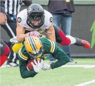  ?? AMBER BRACKEN THE CANADIAN PRESS ?? Ottawa’s Jean-Philippe Bolduc tackles Edmonton’s Bryant Mitchell in a CFL game on Oct. 13. The Redblacks (11-7) are the only team in the East with a better record than the Eskimos (9-9).