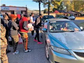 ?? AP PHOTO/ADRIAN SAINZ ?? Friends of slain rapper Young Dolph distribute turkeys outside St. James Missionary Baptist Church on Friday in Memphis.