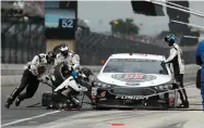  ?? ROB BAKER ?? The car driven by NASCAR Cup Series driver Kevin Harvick (4) is serviced on a pit stop during the NASCAR Brickyard 400 auto race at Indianapol­is Motor Speedway, in Indianapol­is Monday, Sept. 10.