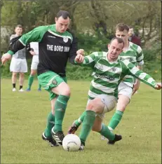  ??  ?? Cloughbawn’s Martin Kehoe is challenged by Neil Howlin.