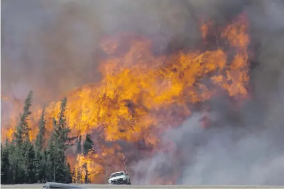  ?? JONATHAN HAYWARD/THE CANADIAN PRESS ?? Analysts predict oil prices driven higher by production stoppages during the Fort McMurray wildfires will bolster the bottom lines of oil and gas firms.