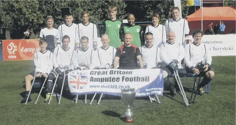  ??  ?? JOURNEY: Pete Wild and the England Amputee Football Team with the Amp Futbol Cup they won in Poland.