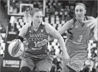  ?? JIM MONE/AP PHOTO ?? Diana Taurasi of the Mercury, right, tries to reach the ball as Lindsay Whalen of the Lynx drives in the first quarter of Wednesday’s WNBA playoff game at St. Paul, Minn. The Lynx won 113-95.