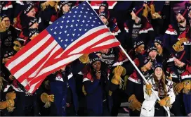  ?? HARRY HOW / GETTY IMAGES ?? U.S. flag bearer Erin Hamlin, who competes in the luge, leads her team during the opening ceremony of the Pyeongchan­g Games.