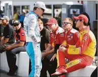  ?? Jeff Curry / Getty Images ?? Kevin Harvick, left, and Joey Logano, right, talk on the grid during qualifying for the NASCAR Cup Series Enjoy Illinois 300 at WWT Raceway on Saturday in Madison, Ill.