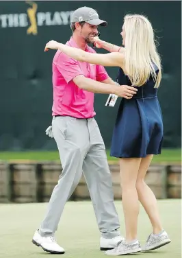  ?? JOHN RAOUOX/THE ASSOCIATED PRESS ?? Webb Simpson is greeted by wife Taylor Dowd Simpson after winning The Players Championsh­ip Sunday. The win moved him to No. 20 in the rankings.