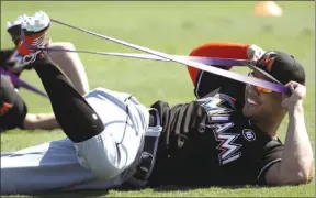  ?? The Associated Press ?? Miami Marlins right fielder Giancarlo Stanton stretches during a spring training baseball workout Friday in Jupiter, Fla. Off the field, multiple groups are interested in purchasing the Marlins, according to team president David Samson, who confirmed owner Jeffrey Loria is being considered for nomination as U.S. ambassador to France.That process has apparently halted talks of a potential sale — at least temporaril­y. A group led by Joshua Kushner, whose brother, Jared, is married to U.S. President Donald Trump’s daughter Ivanka, led a group that had a preliminar­y agreement to buy the Marlins for about $1.6 billion. The Kushner family released a statement Thursday that it would not pursue the Marlins if Loria is nominated. Loria, the former Montreal Expos owner, bought the Marlins for $158.5 million in 2002 from John Henry, now part of the Boston Red Sox ownership group.