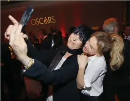  ?? PHOTO BY DANNY MOLOSHOK — INVISION ?? Diane Warren, left, and Renee Zellweger take a selfie at the 92nd Academy Awards Nominees Luncheon at the Loews Hotel on Monday in Los Angeles.