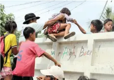  ??  ?? VILLAGERS evacuate a coastal area in the town of Baler, Aurura province, Philippine­s, yesterday. Authoritie­s also started evacuating residents in parts of Central Luzon island as Typhoon Yutu approached the region, threatenin­g to unleash floods, landslides and storm surges. | EPA