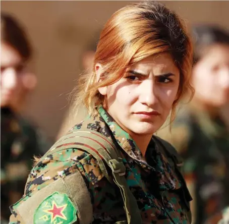  ?? A Syrian Democratic Forces member during the funeral of a fellow fighter in the Kurdish-controlled city of Qamishli in northeaste­rn Syria. ??