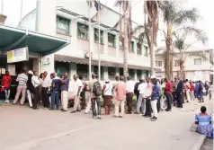  ?? - Picture: Kudakwashe Hunda ?? Consumers queue to buy electricit­y tokens from a Zesa office along Wynne Street in Harare yesterday. Buying the tokens through other platforms has been difficult of late.
