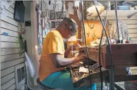  ?? Photograph­s by Carolyn Cole
Los Angeles Times ?? EARL HARLEY, 80, cuts metal into the shape of Africa at his shop in Harlem, N.Y. He sends his elaborate buckles to celebritie­s and politician­s as gifts.